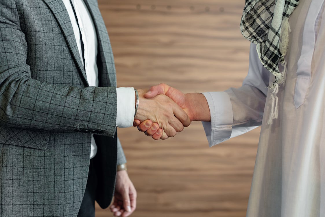 Business handshake symbolizing data broker companies buying and selling personal information