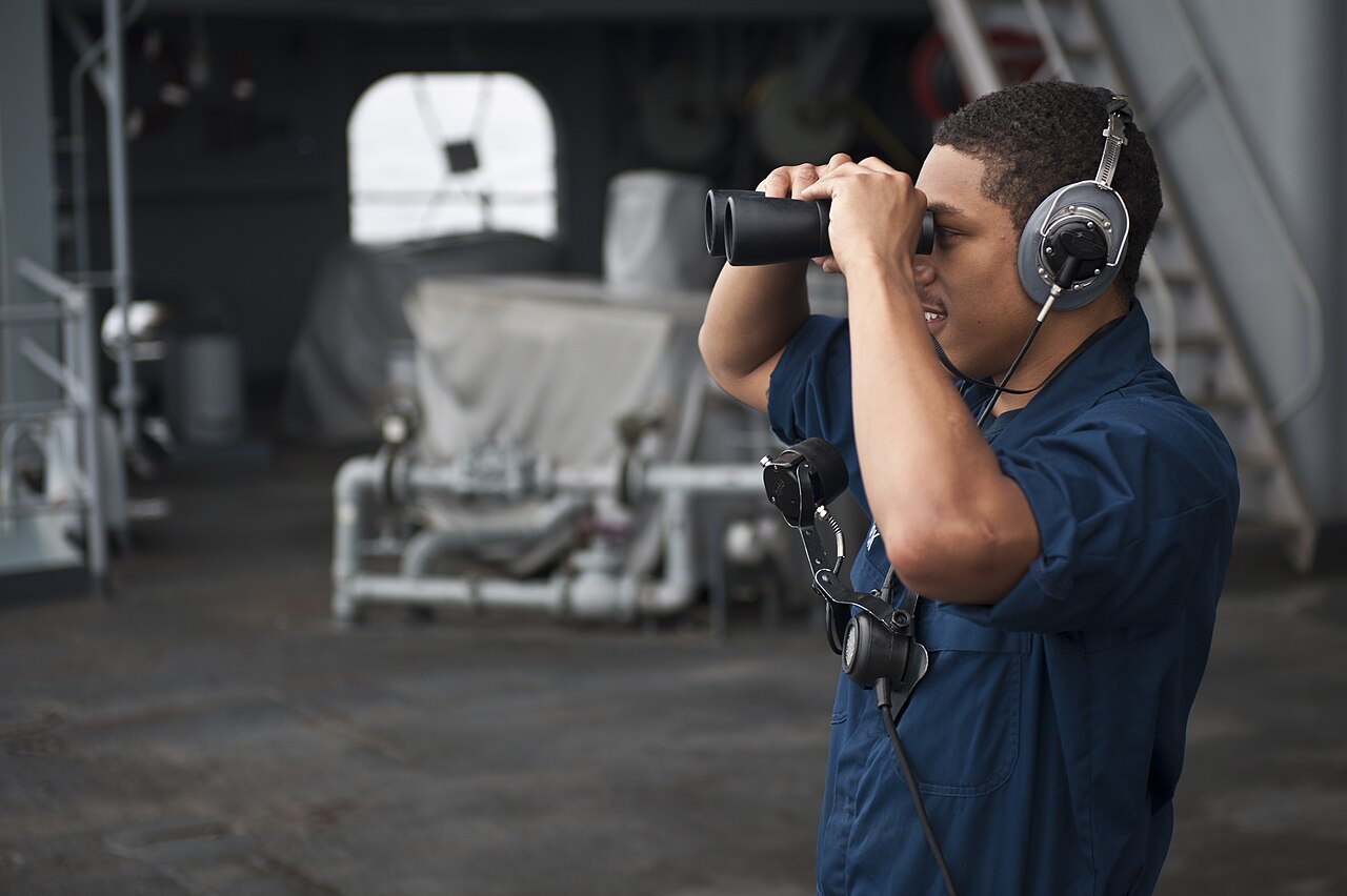 Person looking through binoculars to symbolize website tracking and online surveillance